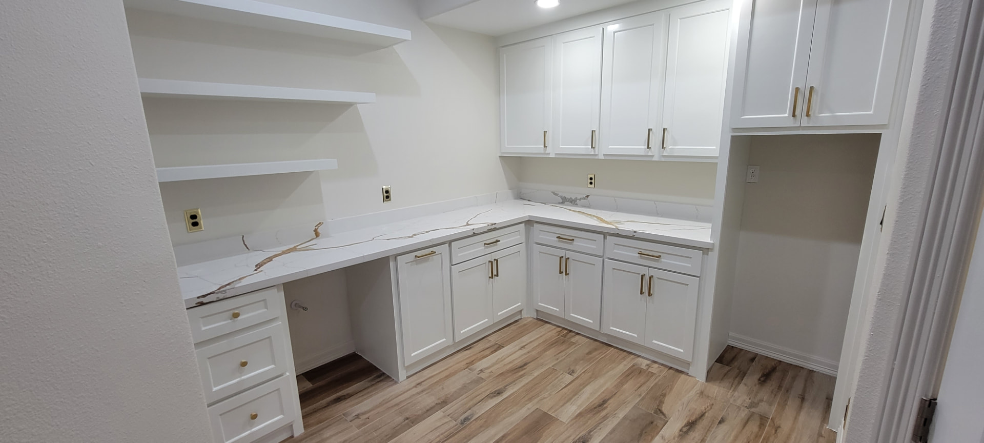 Built-in laundry room with custom cabinets and countertops