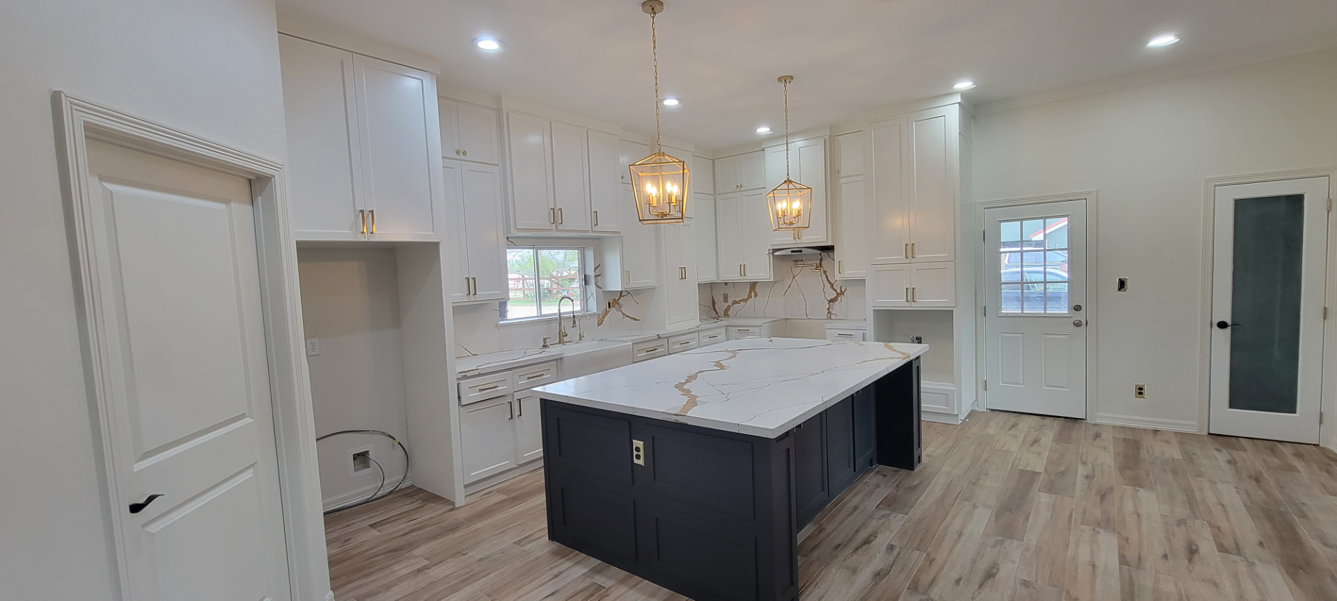 Custom kitchen island with marble countertops and white cabinetry