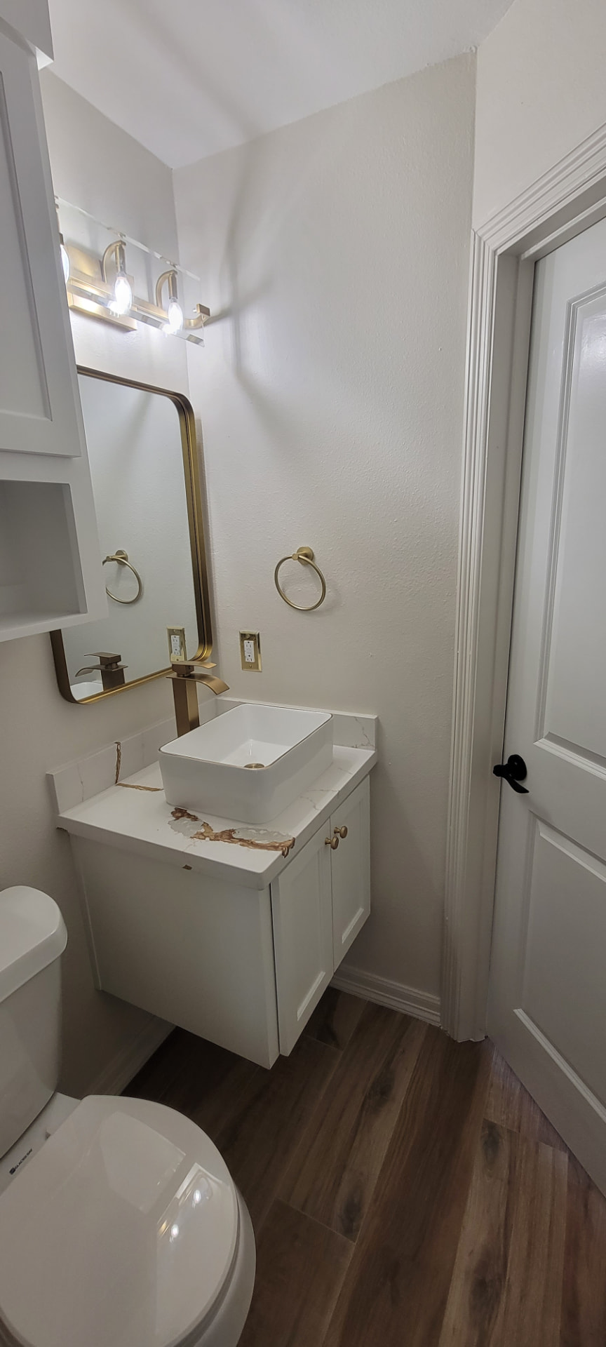 Elegant bathroom vanity with vessel sink and brass fixtures